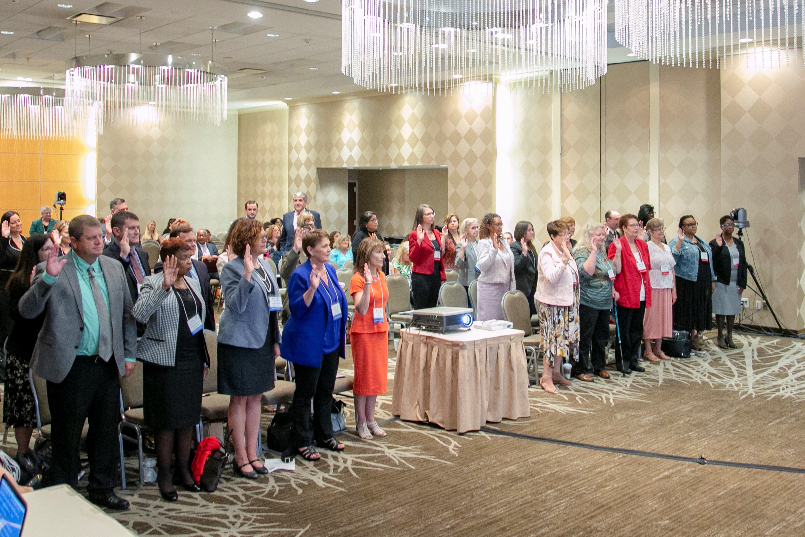 Family Caregiving Advisory Council and Supporting Grandparents Raising Grandchildren Council members completing the oath of office