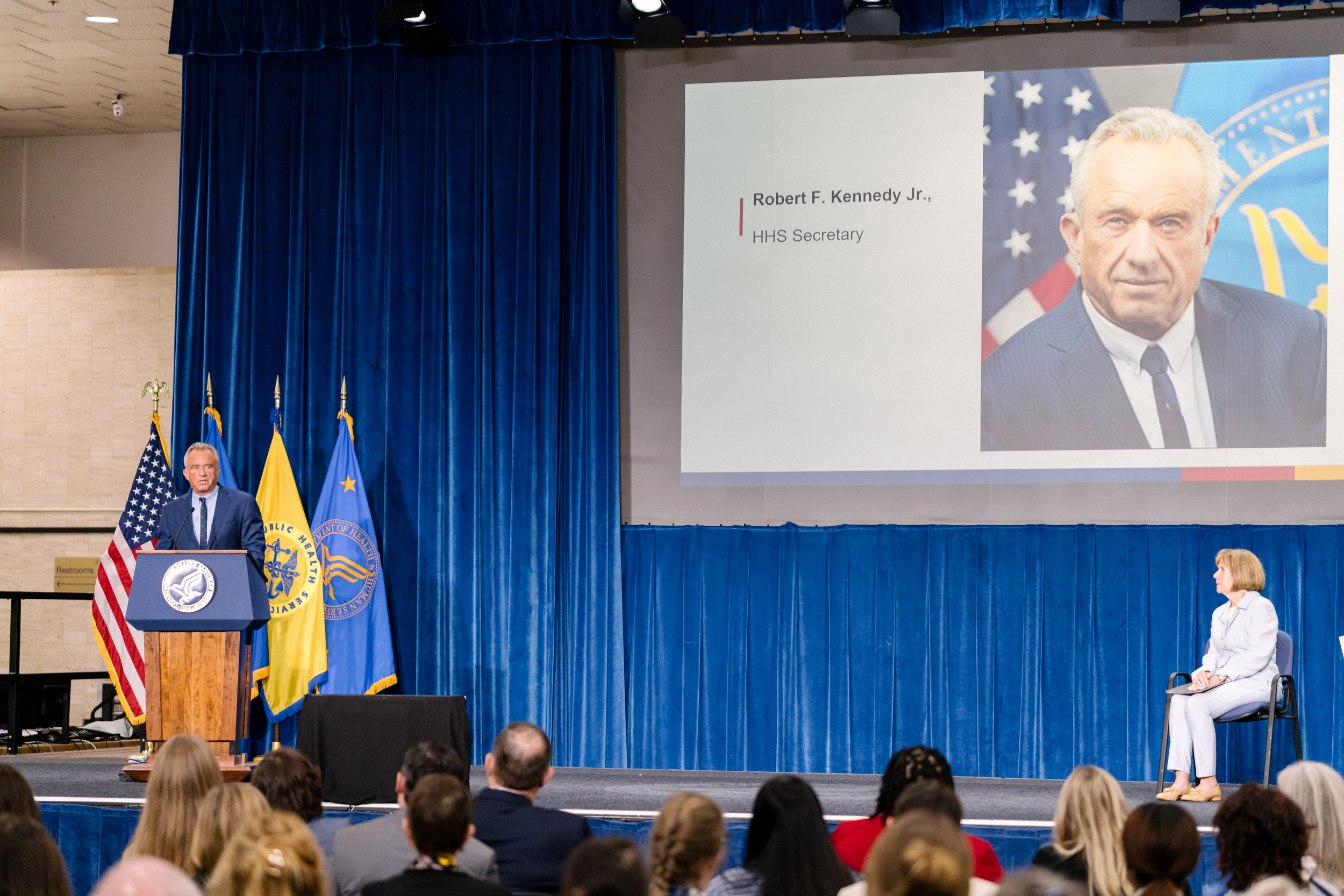 HHS Secretary Robert F. Kennedy Jr. speaking on stage at the podium during the ADA 35th Anniversary event